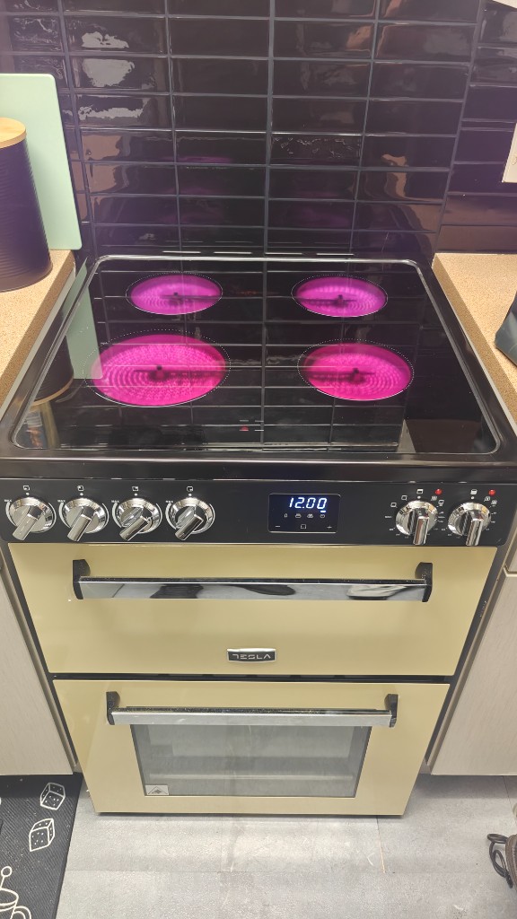 Cream Tesla freestanding electric cooker with ceramic hob installed in a kitchen