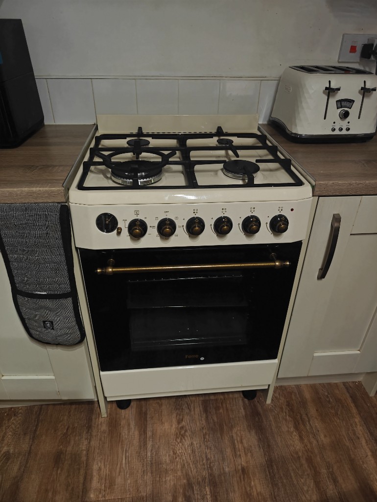 Cream Ferre gas cooker with brass fittings in a white kitchen